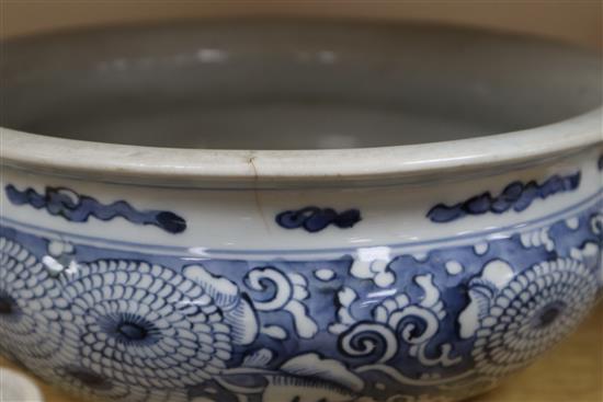 A Chinese blue and white large tripod censer, a peach bloom brush washer and a famille verte vase